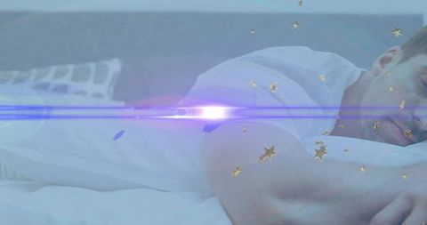 Resting man on bed with dreamy lens flare and gold star overlays