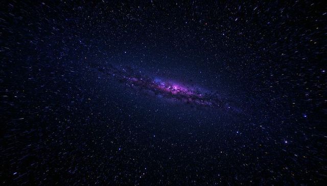 Elongated Purple Galaxy Band Stretching Across Starfield with Radiant Magenta Core
