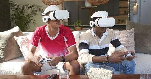 Diverse Friends Engaged in VR Gaming Experience at Home