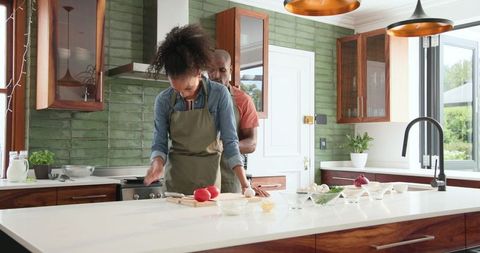 Couple Cooking Together in Modern Kitchen Smiling