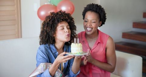 Friends Enjoying Birthday Celebration at Home with Cake