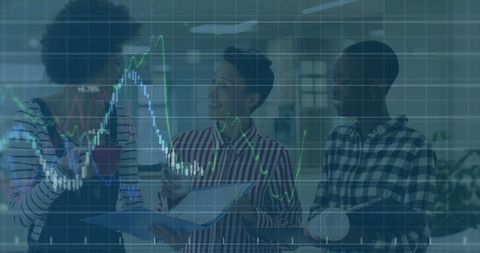Multiracial colleagues analyzing business and financial graphs in office
