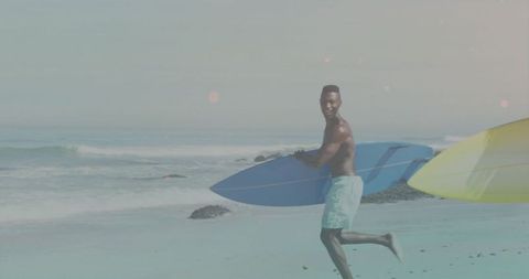 Running Surfer Holding Blue Surfboard on Sandy Beach