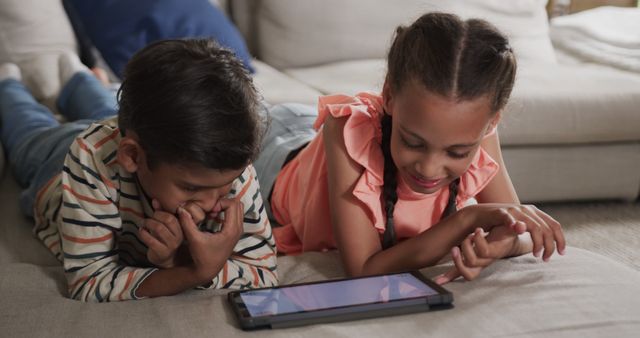 Children Using Tablet Device Relaxing on Sofa - Download Free Stock Images Pikwizard.com