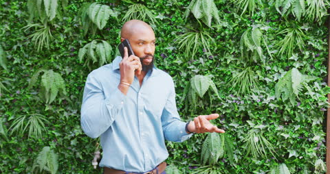 Confident Businessman Engaging in Conversation in Urban Jungle