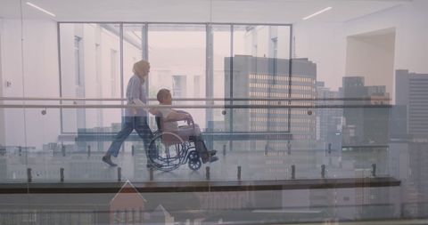 Nurse Assisting Patient in Wheelchair Against Cityscape View - Download Free Stock Images Pikwizard.com