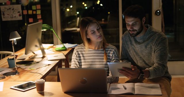 Young professionals working in modern office at night - Download Free Stock Images Pikwizard.com