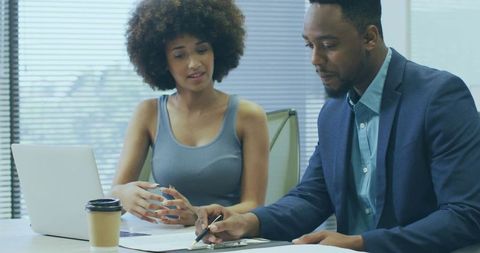 Business Colleagues Reviewing Documents in Office Meeting