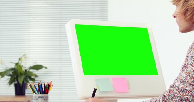Caucasian man using computer with green screen with copy space. Technology, connection, communication and lifestyle concept, unaltered.