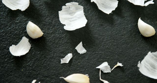 Garlic Cloves and Skins Spread on Black Surface - Download Free Stock Images Pikwizard.com