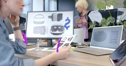 Tan-Skinned Designer Comparing VR Headset Concepts in Collaborative Modern Tech Workspace