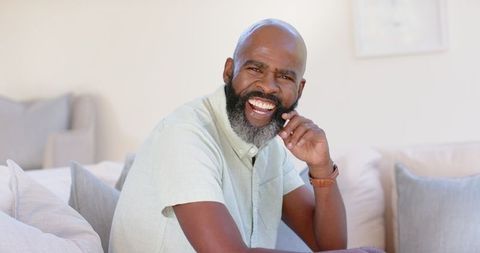 Smiling Man Relaxing on Couch at Home - Download Free Stock Images Pikwizard.com