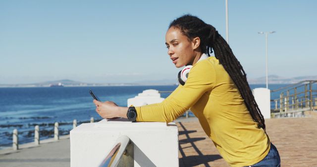 Woman Relaxing by Ocean Waterfront Using Smartphone - Download Free Stock Images Pikwizard.com