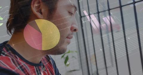 Man Analyzing Smartphone Data with Digital Interfaces In Background