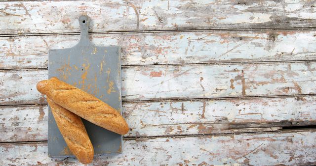 Rustic Wooden Background with Freshly Baked Baguettes on Cutting Board - Download Free Stock Images Pikwizard.com