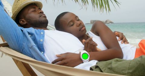 Relaxed Father and Son Enjoying Beach Hammock