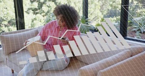 Reviewing property investment papers while holding house model and analyzing growth chart