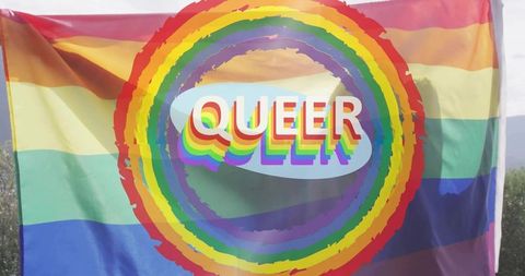 Waving rainbow pride flag featuring ringed rainbow and 3d queer text over sunlit hills