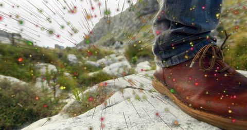 Hiking boot and jeans with radiating colorful particle effect