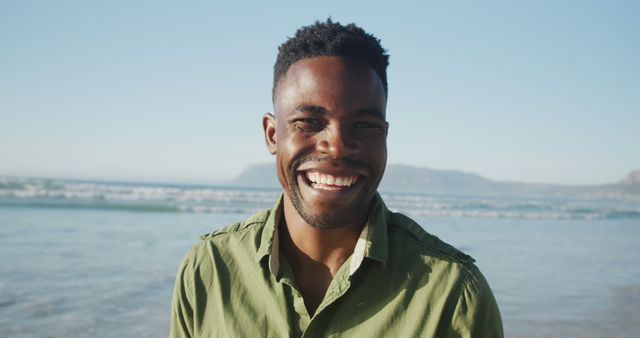 Smiling Man on Beach with Blue Sky Background - Download Free Stock Images Pikwizard.com