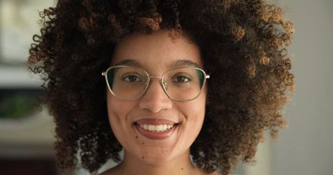 African american woman smiling wearing glasses at home