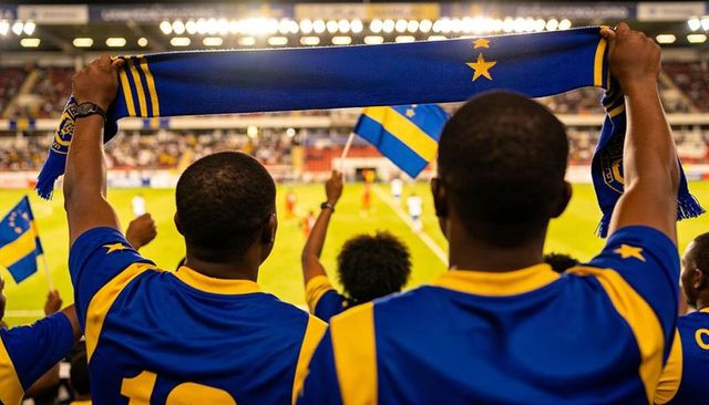 Fans holding scarf overhead in blue and yellow jerseys cheering at night soccer match