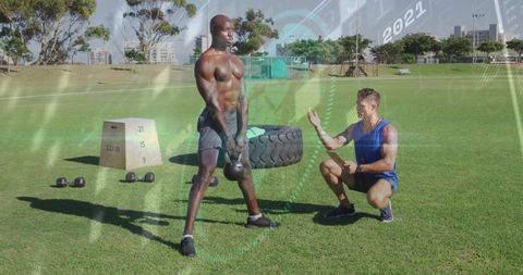 Kettlebell training in park with coach guidance