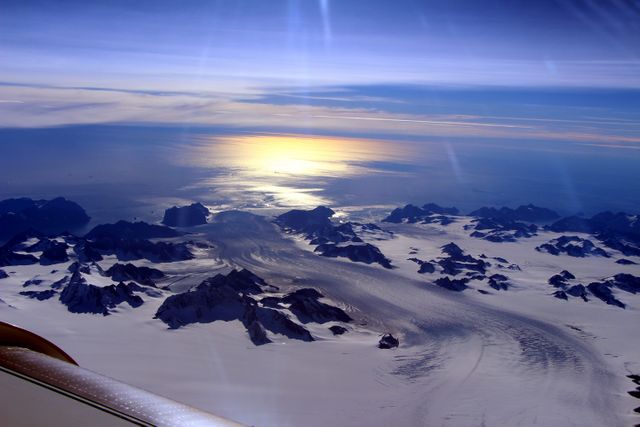NASA's IceBridge, an airborne survey of polar ice, flew over the Helheim/Kangerdlugssuaq region of Greenland on Sept. 11, 2016. This photograph from the flight captures Greenland's Steenstrup Glacier, with the midmorning sun glinting off of the Denmark Strait in the background. IceBridge completed the final flight of the summer campaign to observe the impact of the summer melt season on the ice sheet on Sept. 16.  The IceBridge flights, which began on Aug. 27, are mostly repeats of lines that the team flew in early May, so that scientists can observe changes in ice elevation between the spring and late summer. For this short, end-of-summer campaign, the IceBridge scientists flew aboard an HU-25A Guardian aircraft from NASA's Langley Research Center in Hampton, Virginia.  Credit: NASA/John Sonntag  <b><a href="http://www.nasa.gov/audience/formedia/features/MP_Photo_Guidelines.html" rel="nofollow">NASA image use policy.</a></b>  <b><a href="http://www.nasa.gov/centers/goddard/home/index.html" rel="nofollow">NASA Goddard Space Flight Center</a></b> enables NASA’s mission through four scientific endeavors: Earth Science, Heliophysics, Solar System Exploration, and Astrophysics. Goddard plays a leading role in NASA’s accomplishments by contributing compelling scientific knowledge to advance the Agency’s mission.  <b>Follow us on <a href="http://twitter.com/NASAGoddardPix" rel="nofollow">Twitter</a></b>  <b>Like us on <a href="http://www.facebook.com/pages/Greenbelt-MD/NASA-Goddard/395013845897?ref=tsd" rel="nofollow">Facebook</a></b>  <b>Find us on <a href="http://instagrid.me/nasagoddard/?vm=grid" rel="nofollow">Instagram</a></b>      