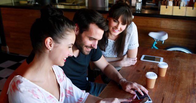 Friends Enjoying Coffee While Using Tablet at Coffee Shop - Download Free Stock Images Pikwizard.com