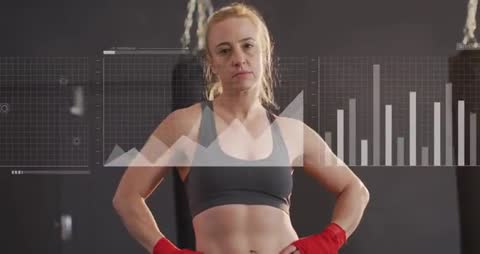 Female boxer standing with hands on hips while performance data overlaying torso