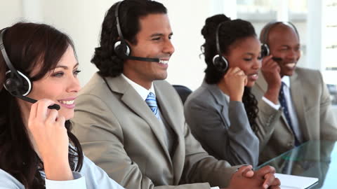 Diverse Team Collaborating in Modern Office with Headsets
