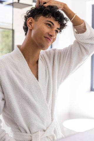 Young Man Grooming in Bathrobe for Morning Routine