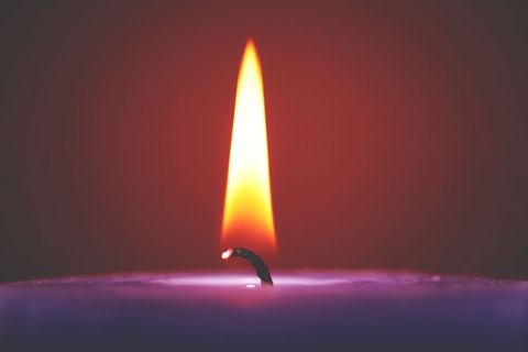 Close-Up of a Burning Candle with Flickering Flame