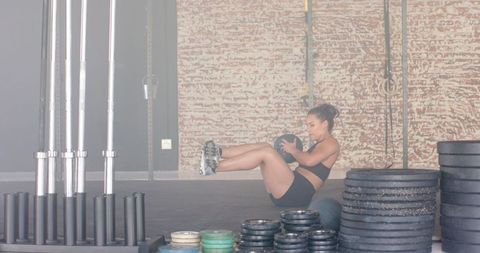 Athletic Woman Performing Core Workout with Medicine Ball
