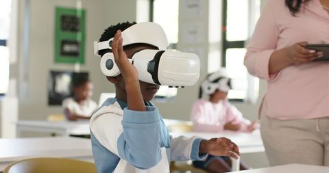African American Student Using Virtual Reality Headset in Classroom Learning Experience