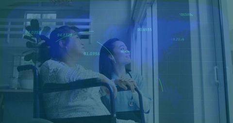 Nurse assisting wheelchair user with technological data monitoring