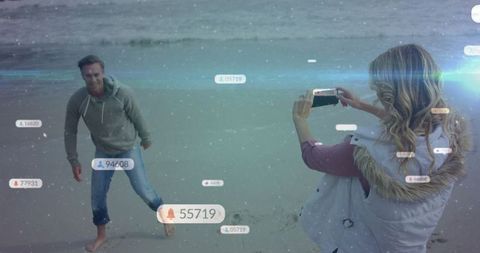 Digital lifestyle: couple enjoying beach amid social media overlays