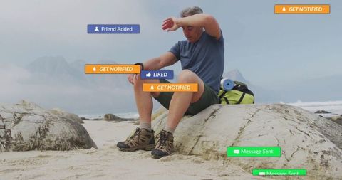 Hiker on rocky beach engaging with virtual social media
