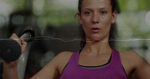 Focused woman lifting dumbbell wearing purple tank top with dotted waveform overlay