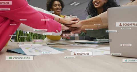 Uniting Team Hands Over Desk with Laptop and AR Data Overlays Showing Collaboration