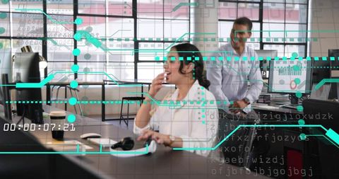 Laughing colleagues collaborating at modern open-plan office with digital data overlays