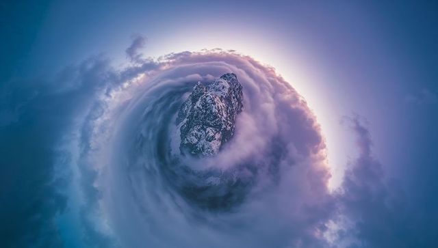 Mystical Mountain Peak in Whirling Vortex with Sunlit Sky