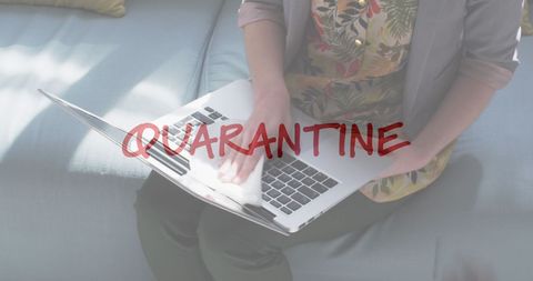Woman Disinfecting Laptop During Quarantine