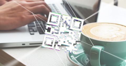 Qr code technology concept with laptop and coffee