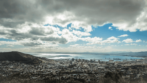 Panoramic View of Urban Skyline with Dramatic Clouds and Ocean in Background - Download Free Stock Videos Pikwizard.com