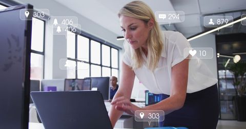Businesswoman Analyzing Social Media Metrics on Laptop