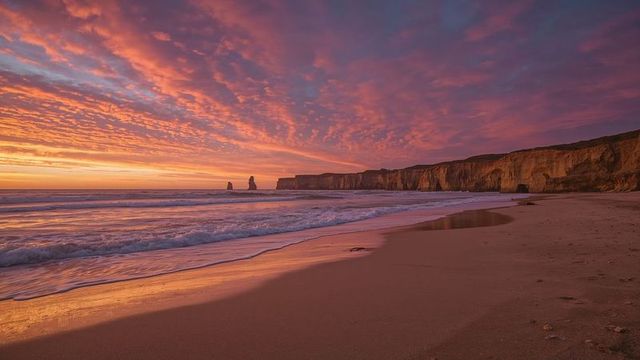 Scenic Beach Sunset with Dramatic Sky over Sea Stacks and Cliffs