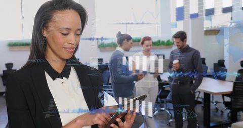 Businesswoman tapping tablet with data overlays in modern open-plan office teamwork