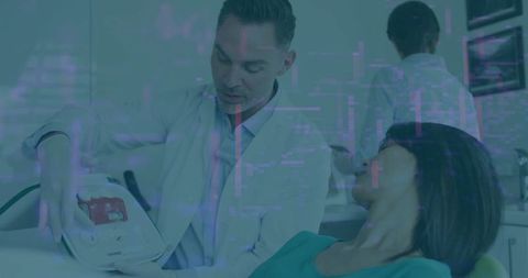 Dentist Presenting Advanced Diagnostic Equipment in Dental Office