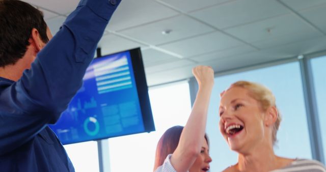 Caucasian professionals jubilantly celebrate a major workplace triumph in a modern office. - Download Free Stock Photos Pikwizard.com